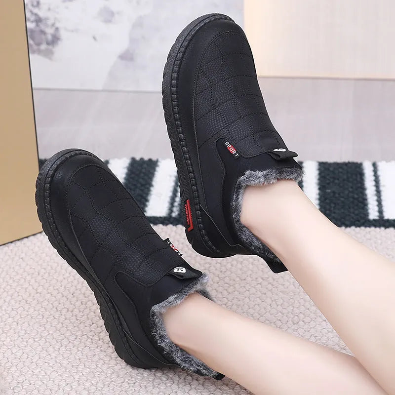 Women's black casual flat ankle boots with round toe and synthetic leather upper on a neutral background.