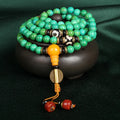 Natural turquoise bracelet with 108 polished 8mm round beads on white background