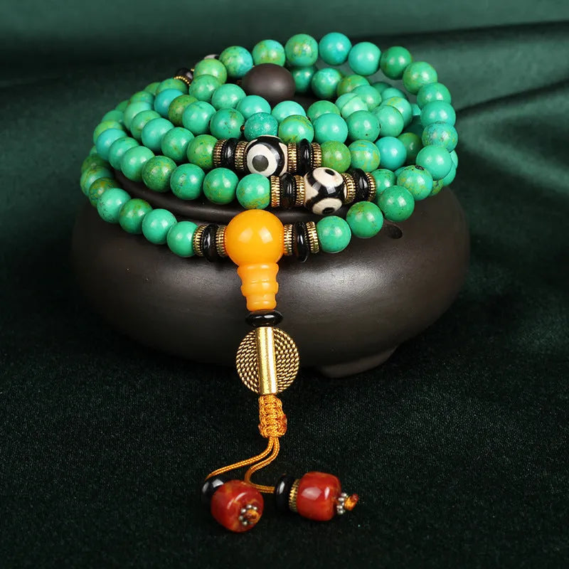 Natural turquoise bracelet with 108 polished 8mm round beads on white background
