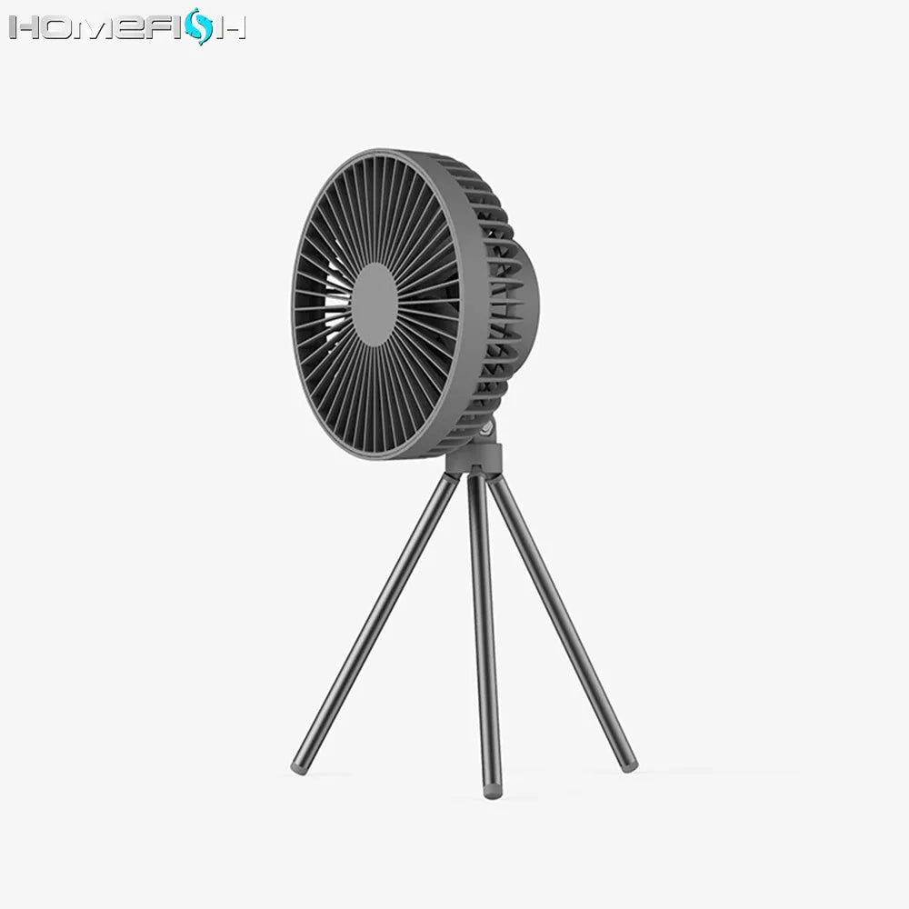 White tripod camping fan on a desk, with USB cable and adjustable speed dial