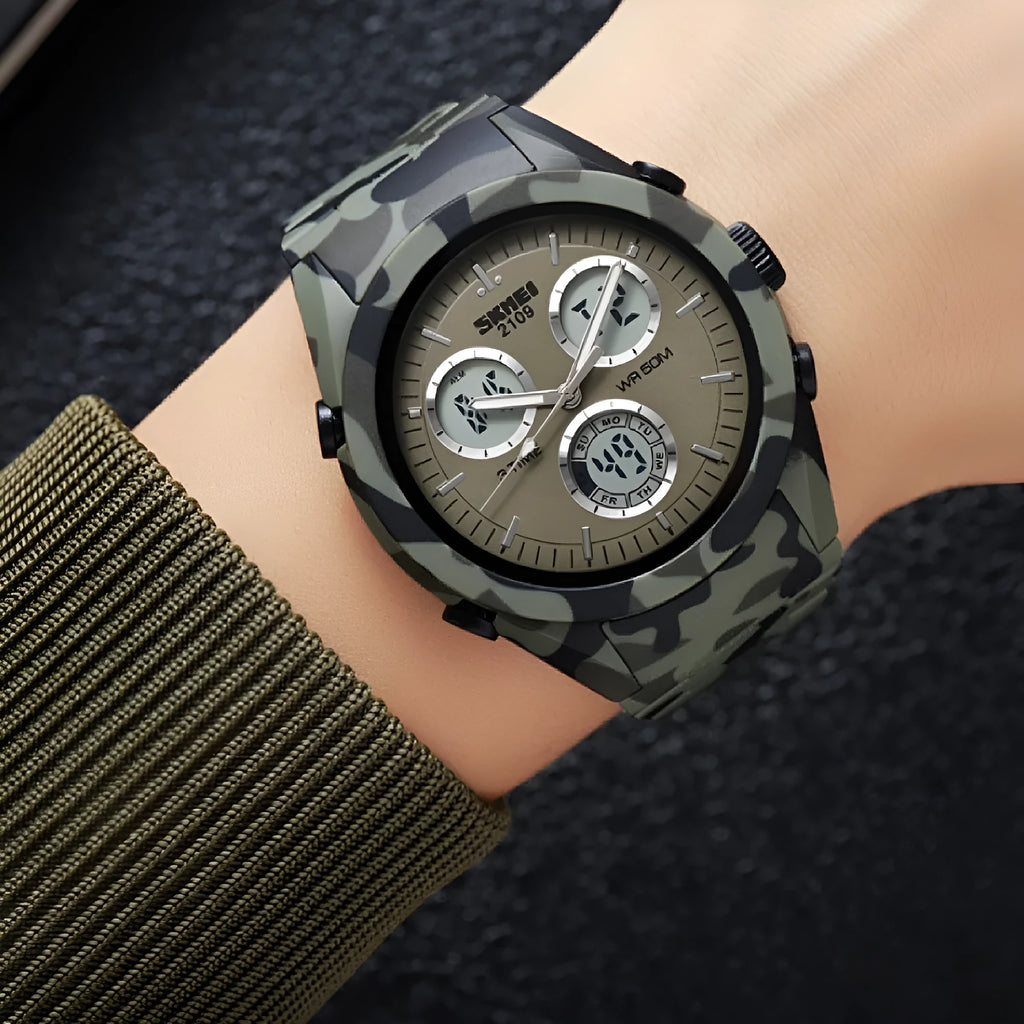 Unisex digital watch with camouflage strap, resin lens, and stainless steel button on a wrist.