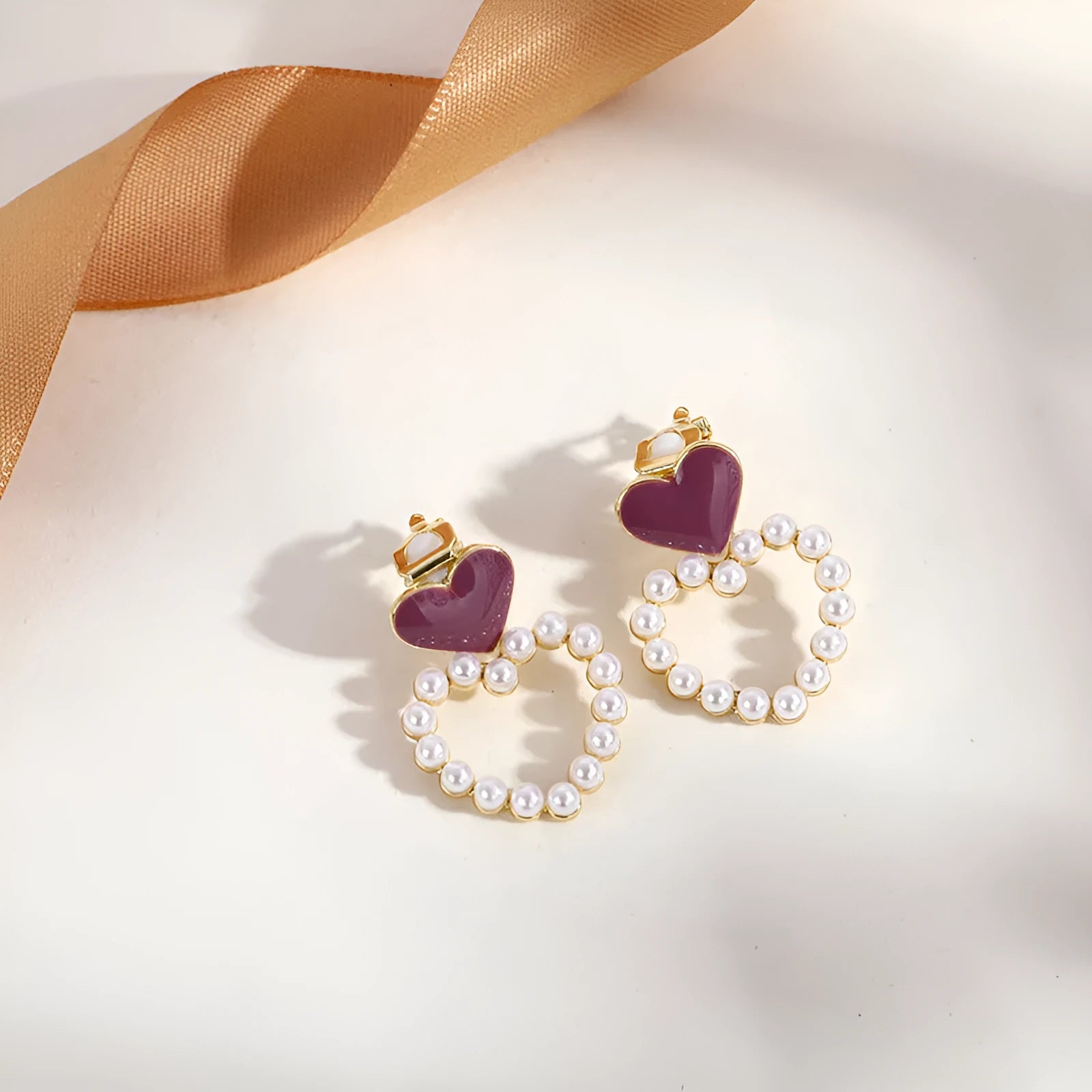 A pair of gold geometric tassel clip-on earrings for non-pierced ears.