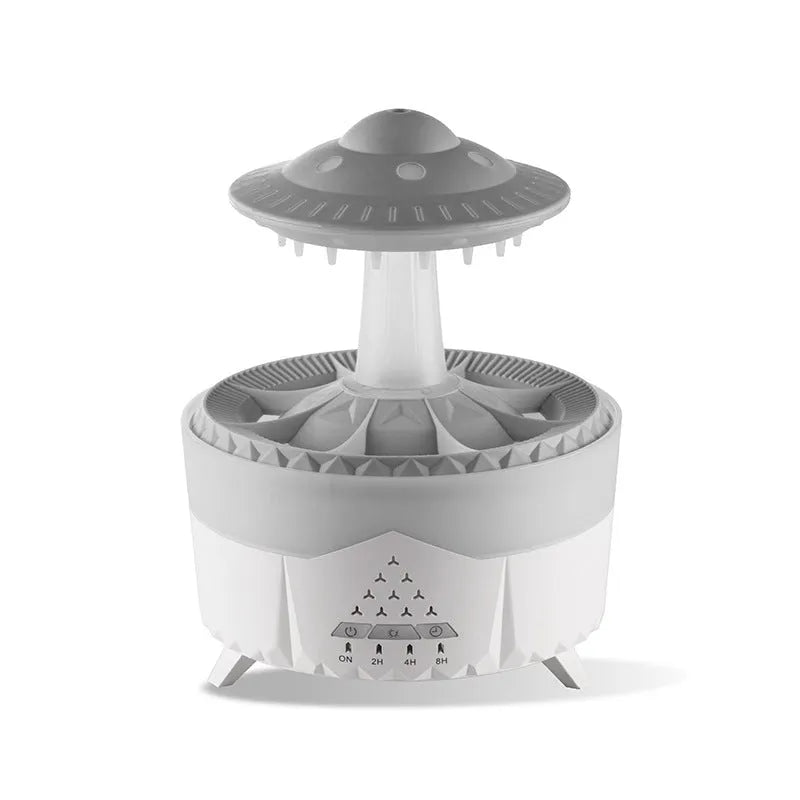 UFO cloud-shaped humidifier with LED lights and water droplet effects on dark surface