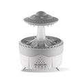 UFO cloud-shaped humidifier with LED lights and water droplet effects on dark surface