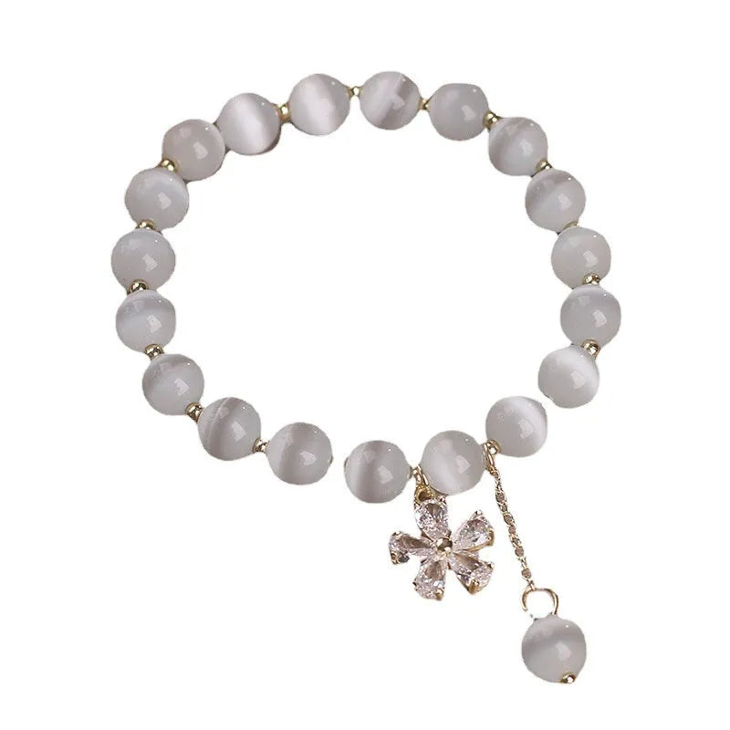 Women's white Cat's Eye crystal bracelet with flower tassel pendant and safety buckle closure