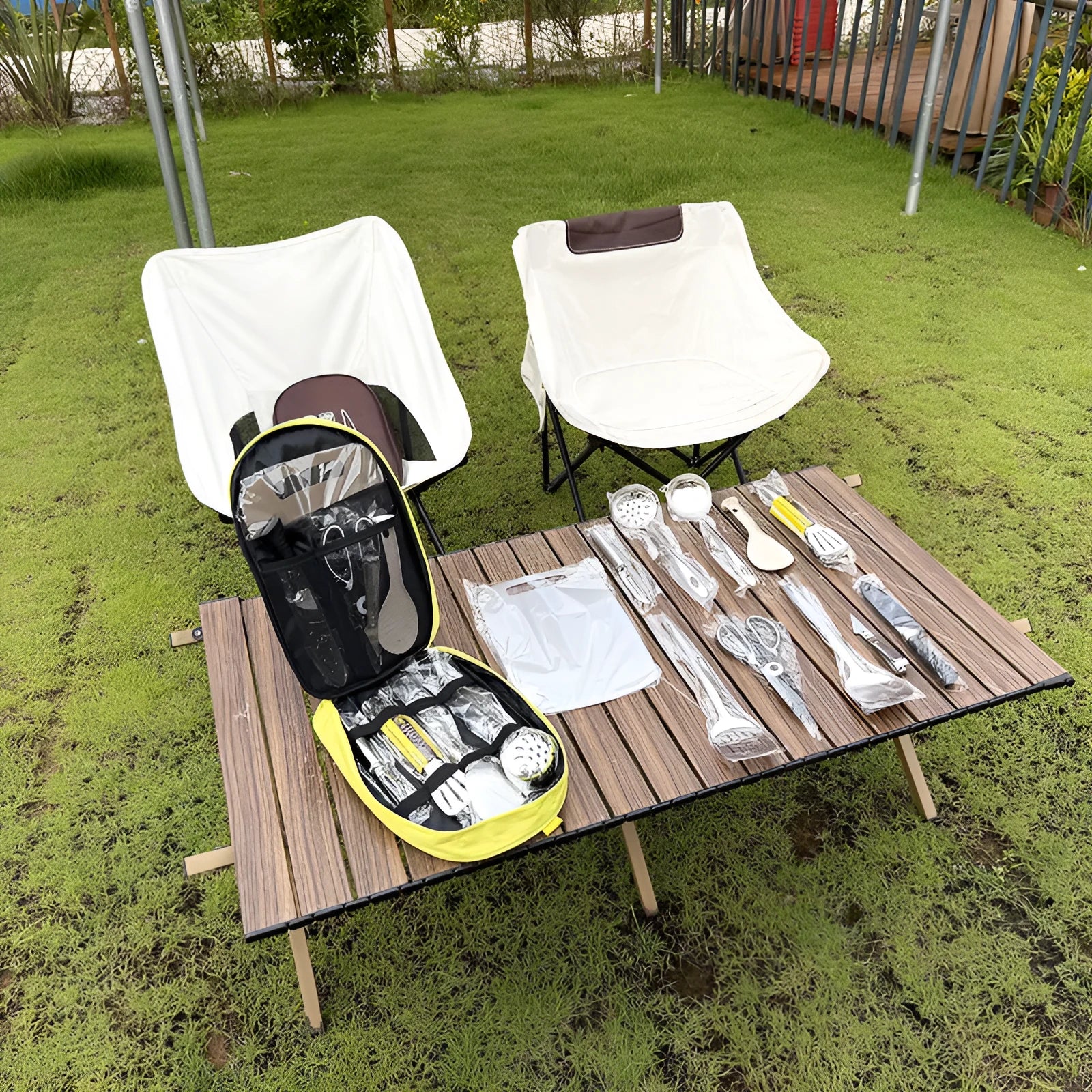 Khaki portable picnic bag unrolled to show 12 stainless steel cutlery pieces.