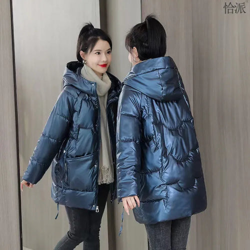 A woman's loose-fit hooded winter jacket in a poly-cotton blend, shown in a choice of colours including black and champagne.