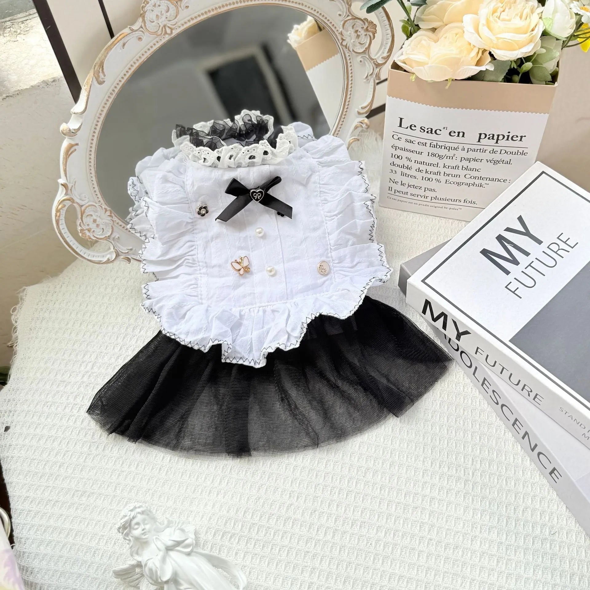 White yarn gauze skirt for small dog on a table, showing princess-style tiered design and lightweight fabric.