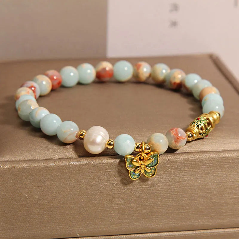 Blue women's bracelet with Shoushan stone, freshwater pearls and butterfly charm pendant