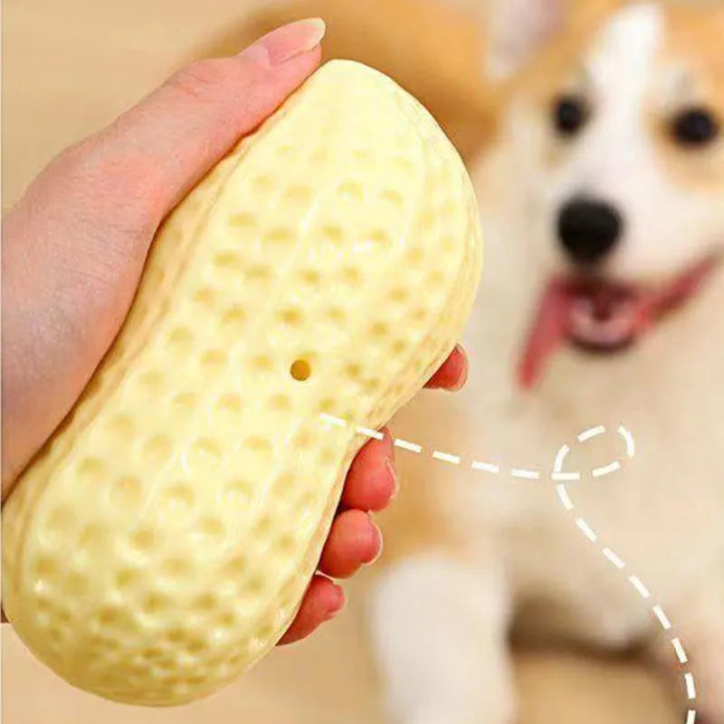 Yellow TPR peanut-shaped dog chew toy with squeaker on a white background