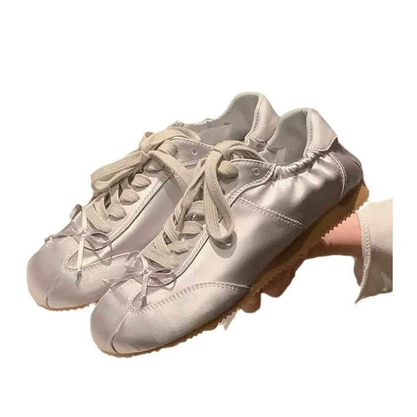 Women's satin ballet flat shoes with round toe and lace-up front in champagne pink colour