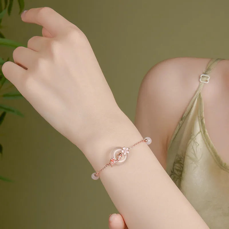 Women's S925 sterling silver bracelet with white chalcedony crystals and electroplated koi fish design.