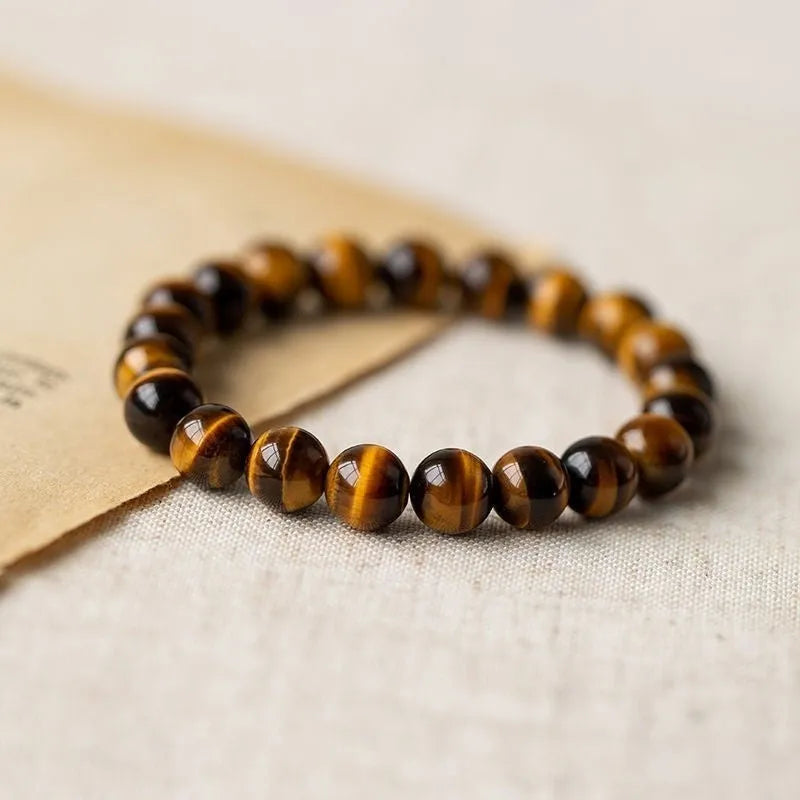 Simple single-circle Tigereye Dzi bead rosary bracelet showing the banded stone, available in multiple bead sizes.