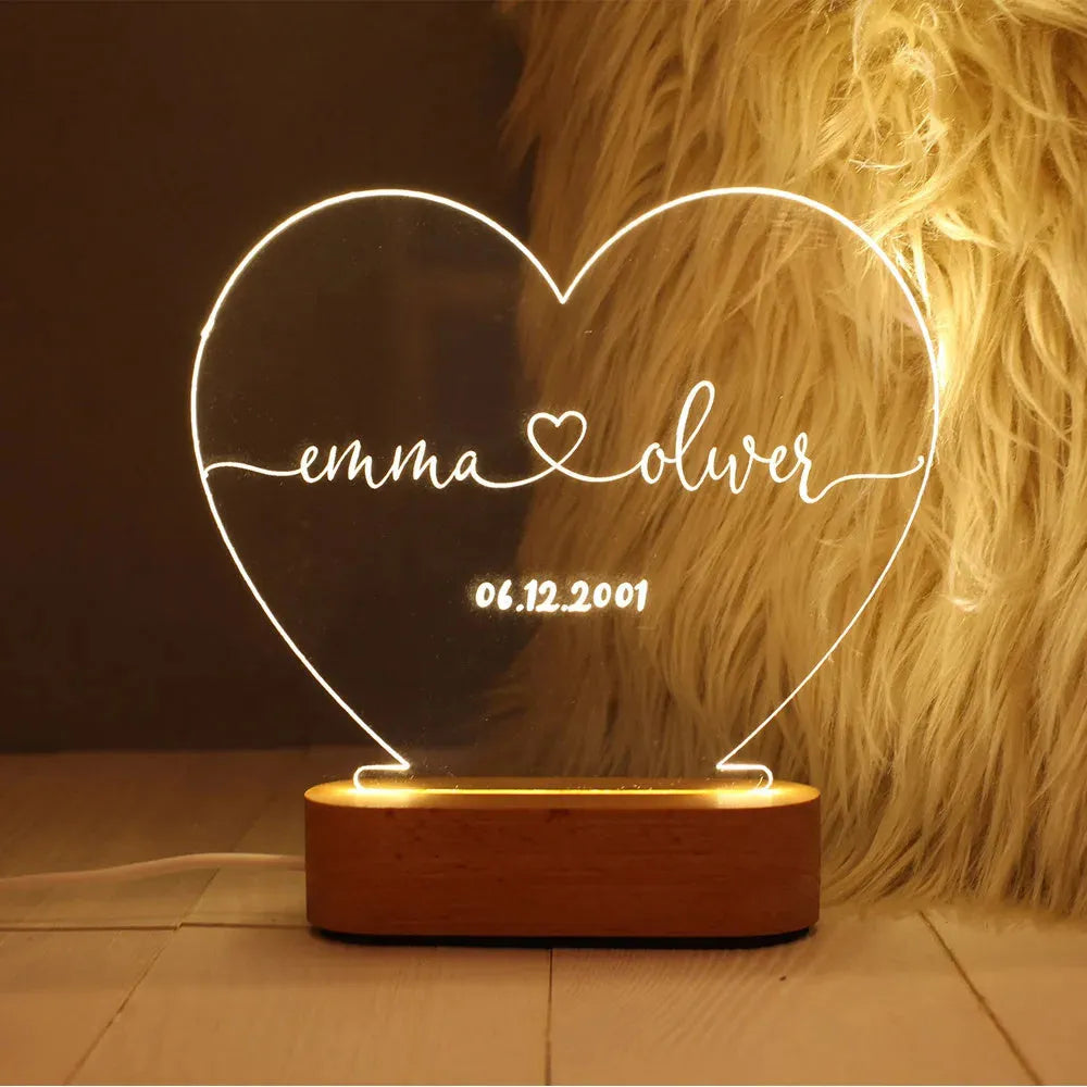 Custom transparent acrylic night light engraved with personal names and a date.