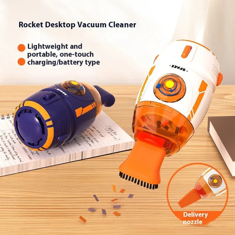 USB-powered handheld desktop vacuum cleaner in blue, placed next to a keyboard with crumbs.