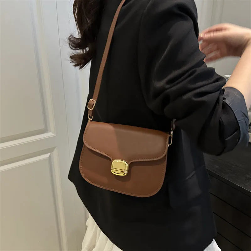 Simple PU handbag for women in one of six colours, showing interior with zippered change purse and phone pocket.