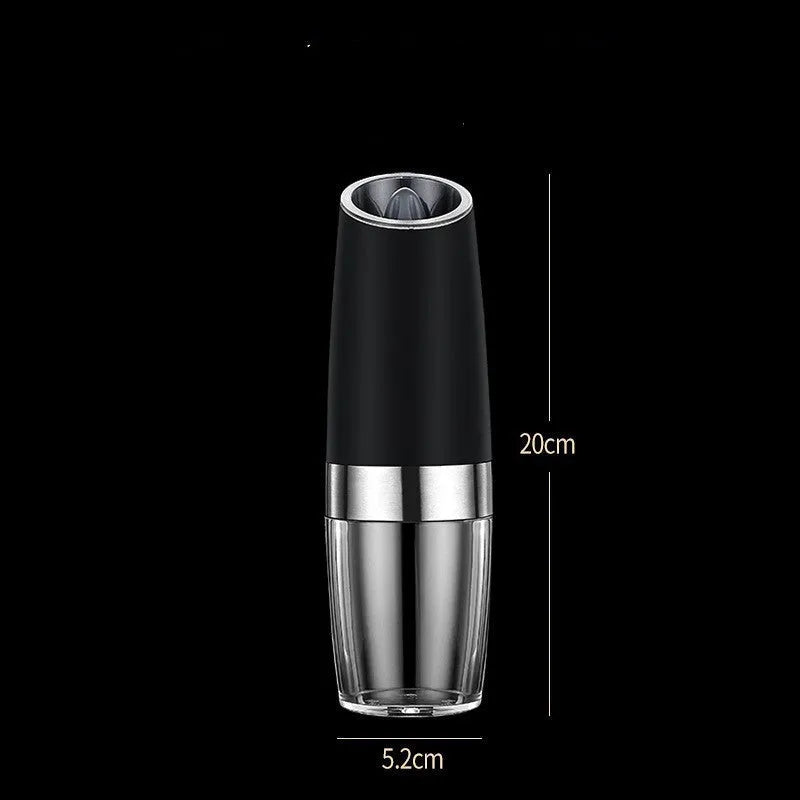 Black and silver electric pepper and salt grinder set with clear acrylic body on a kitchen counter.