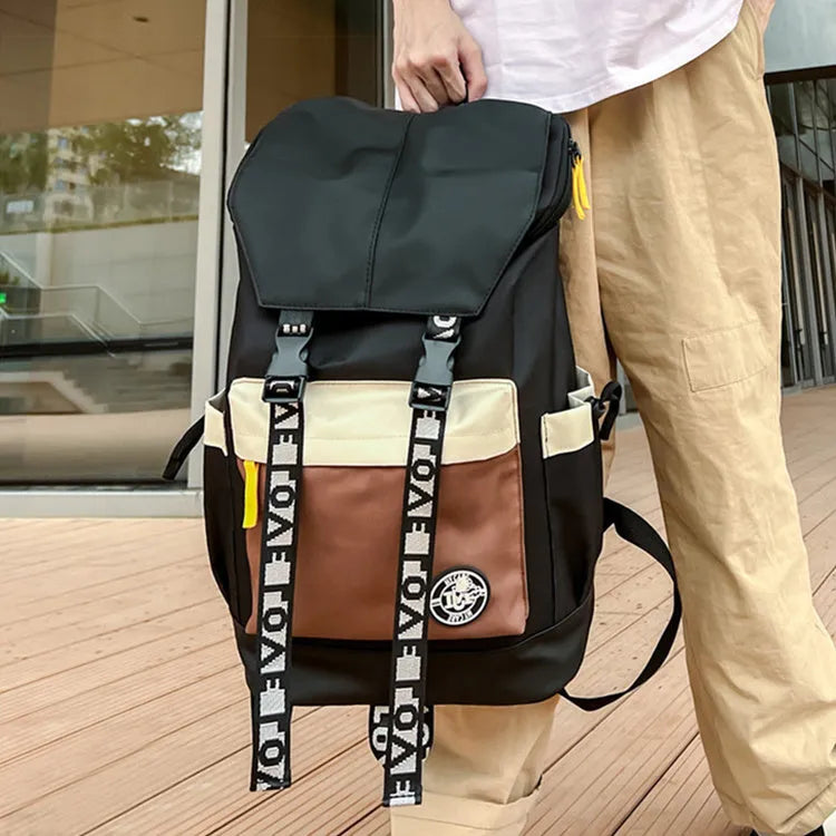 Oxford cloth backpack in black, green, or red with multiple carry handles and straps.