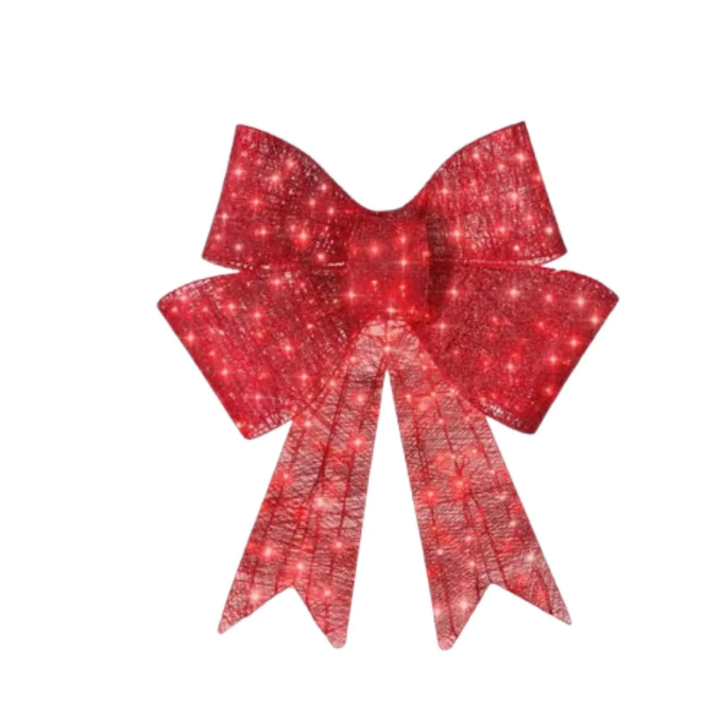 Red satin light up Christmas bowknot on a tree branch with warm glow