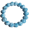Blue bodhi bracelet with natural sea-pattern crystal stones and a single pearl bead.