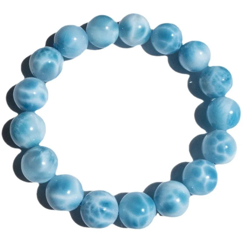 Blue bodhi bracelet with natural sea-pattern crystal stones and a single pearl bead.