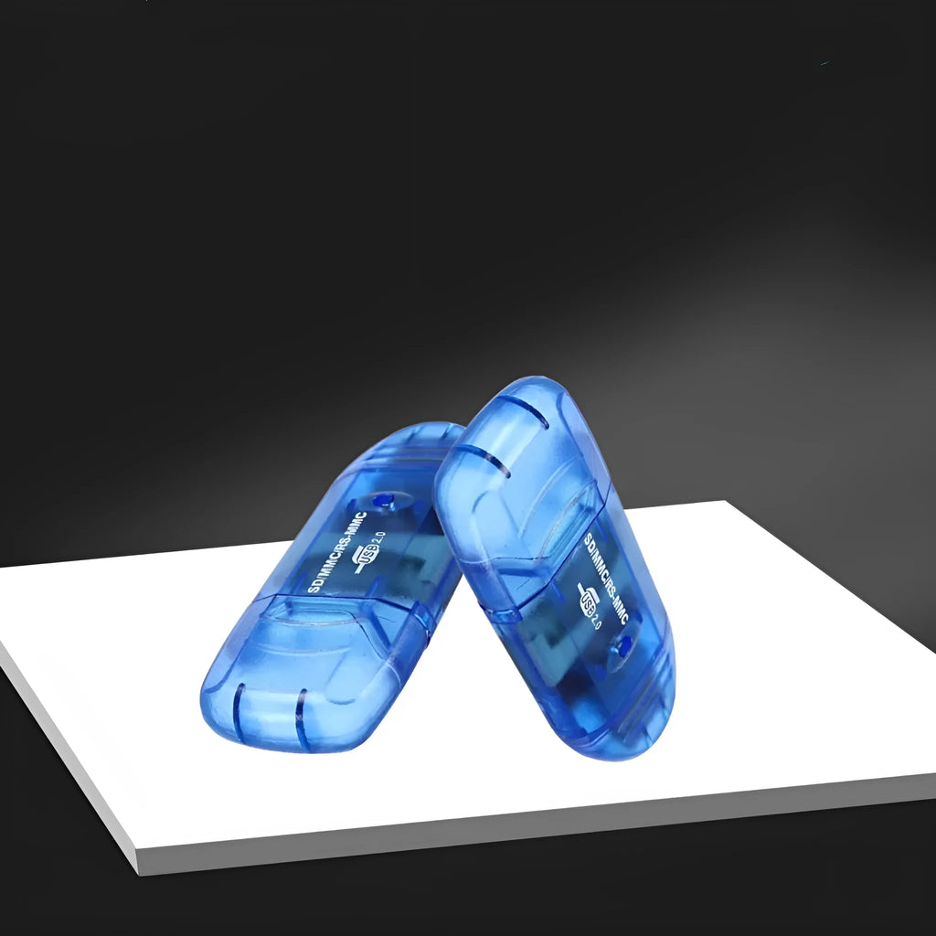 Transparent plastic USB card reader with LED light on a desk.