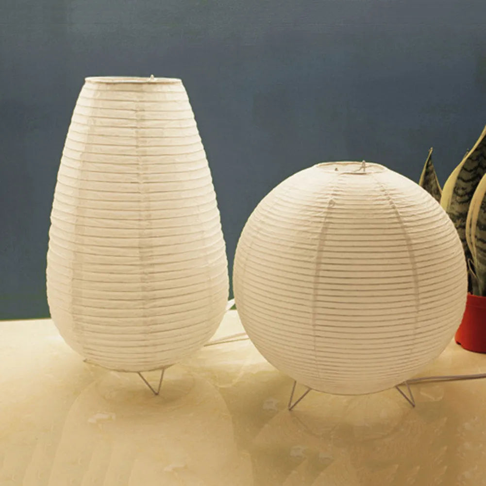 White rice paper table lamp with traditional handwork on bedside table