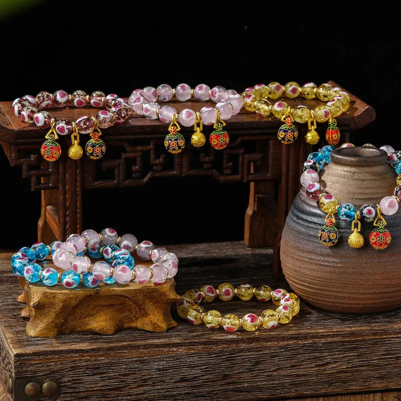 Handmade glass bracelet with swallowing gold beast design on heart-shaped 10mm beads