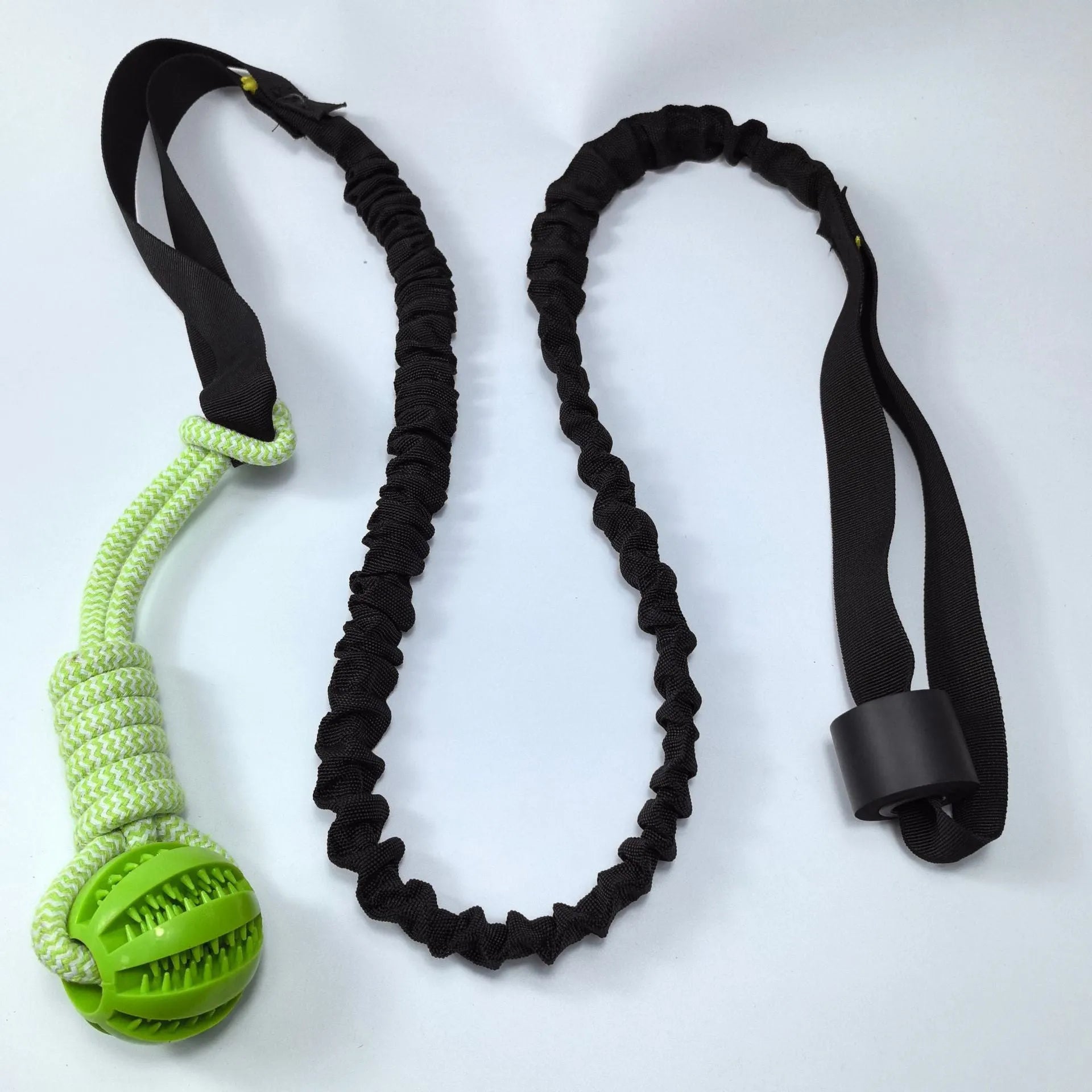 Green cotton rope dog tug toy with a knotted ball handle on a white background.