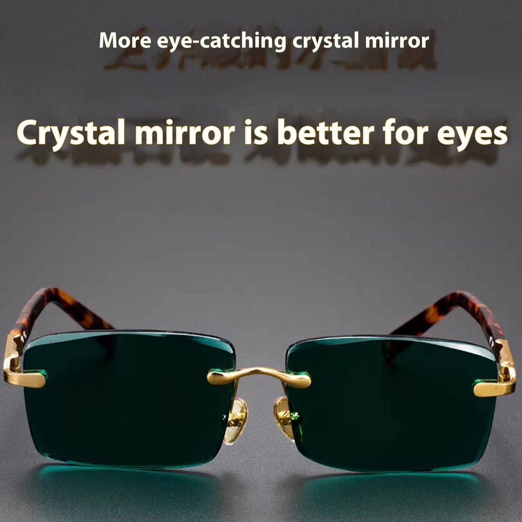Frameless dark green crystal sunglasses with minimalist design on a case with cleaning cloth.