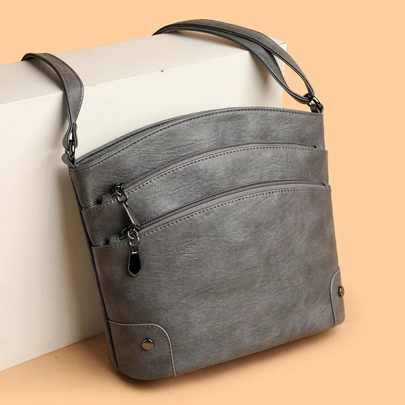 Large capacity PU bucket bag for women in black with multi-layer internal pockets and outer slit pocket