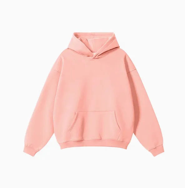Man wearing a loose-fit cotton terry hooded sweater in a grey apricot colour.