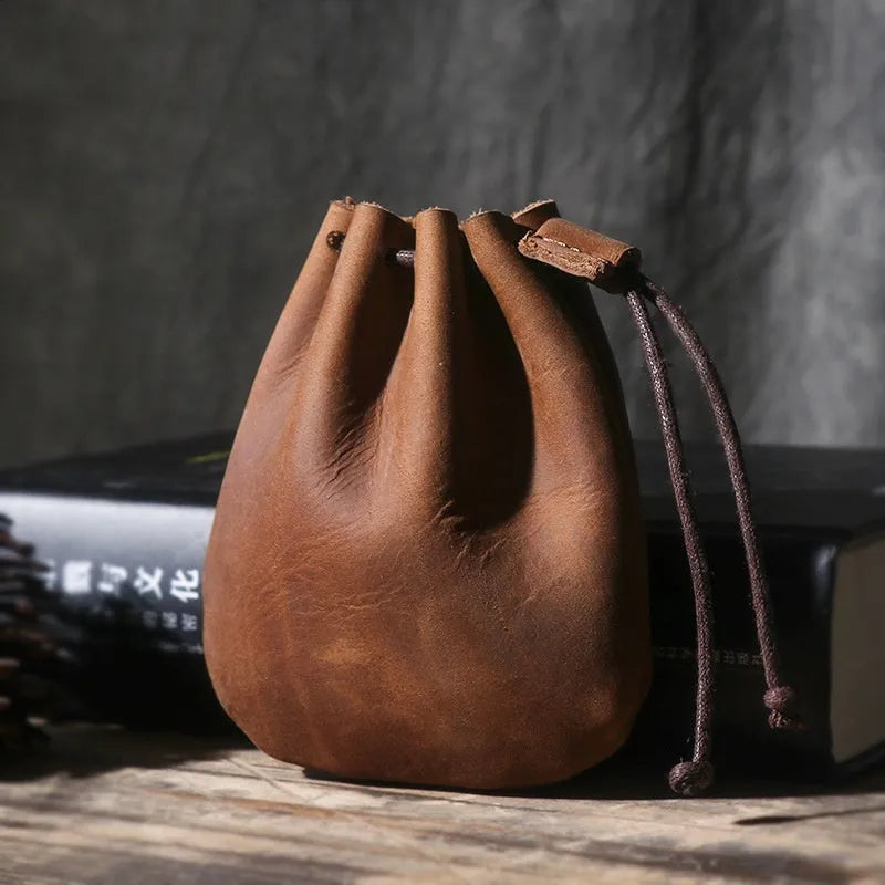 Vintage brown genuine leather drawstring bundle wallet with cinched closure.