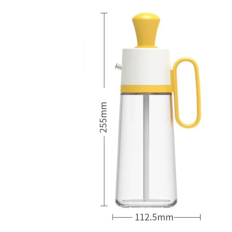 Yellow 2 in 1 oil dispenser with silicone brush next to glass bottle