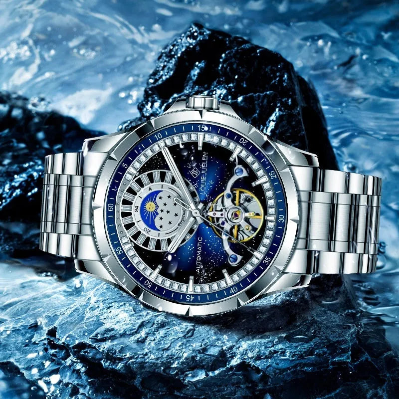Silver men's automatic watch with a blue dial and stainless steel strap on a wrist