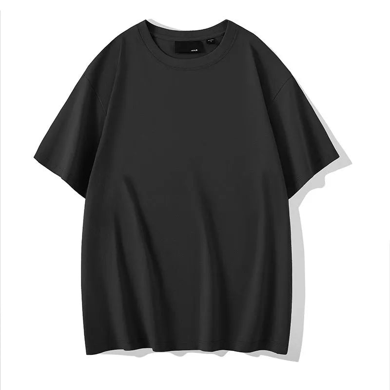 Man wearing a loose-fitting solid colour cotton t-shirt with drop-shoulder sleeves.