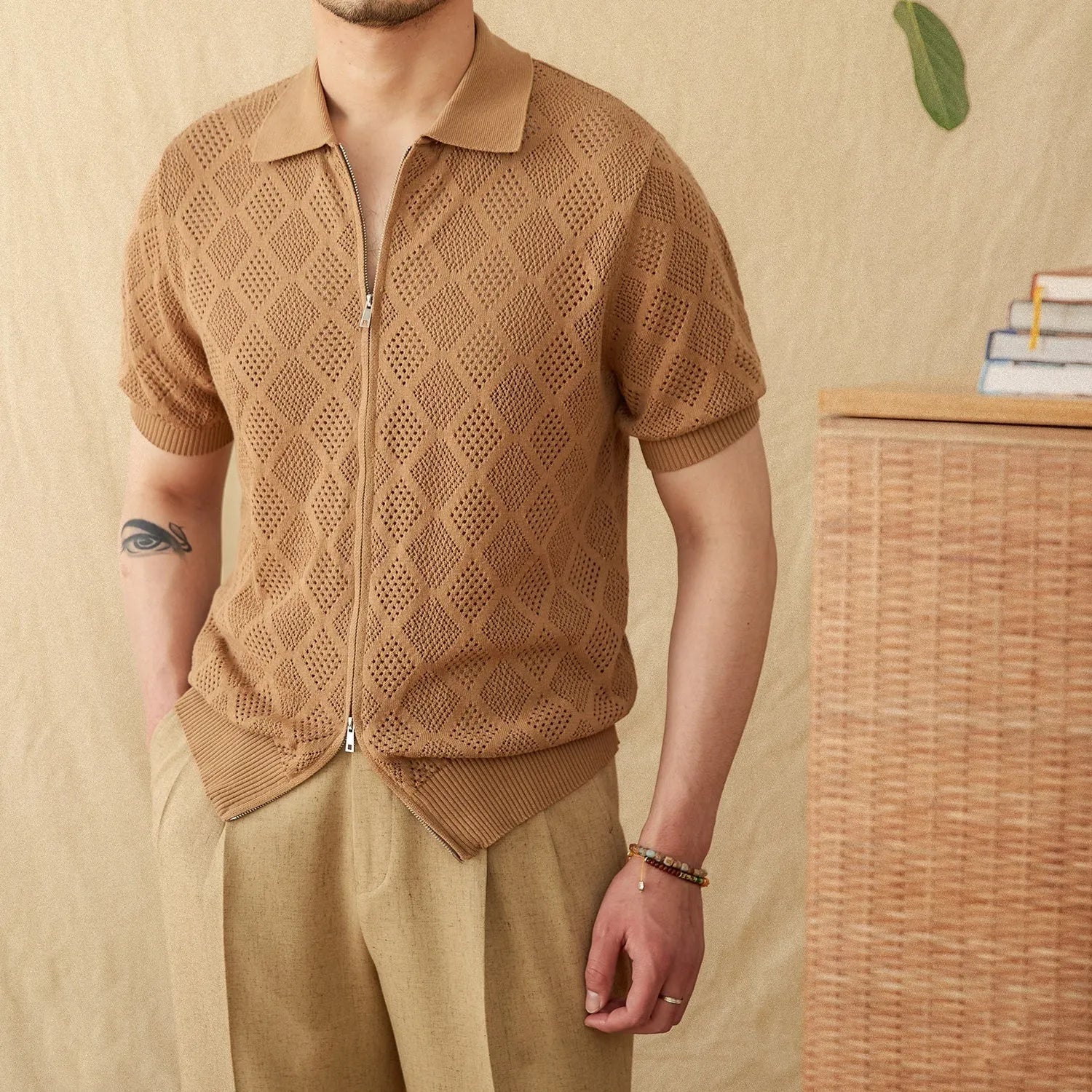 Women's light brown zip-front cotton cardigan with short sleeves and a lapel collar laid flat.
