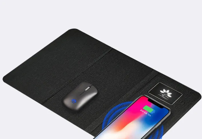Folding wireless charging mouse pad set with compact wireless mouse on branded cloth surface.