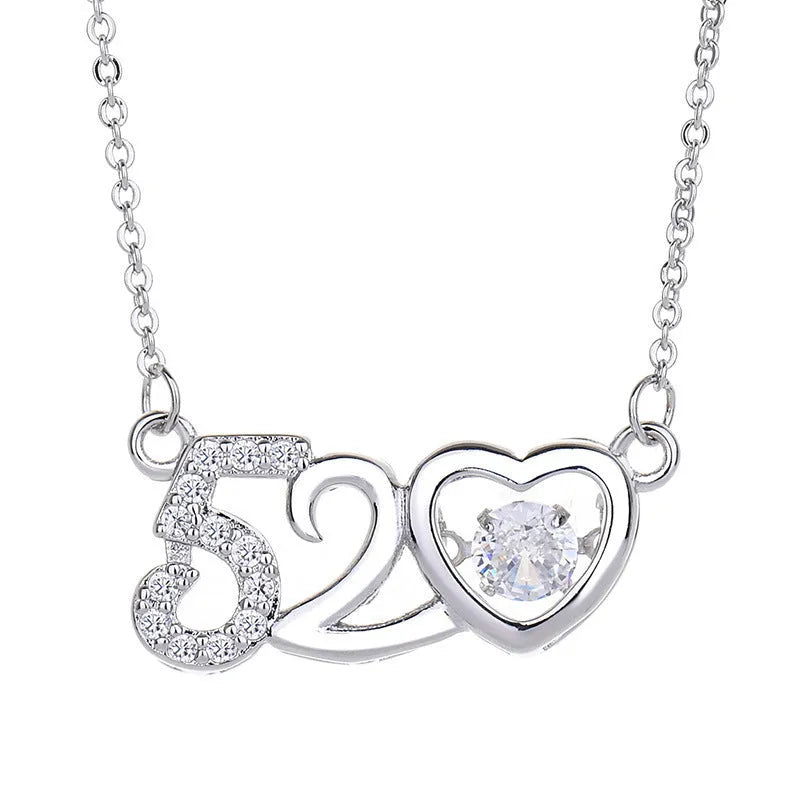 Silver heart necklace with crown and bow detail on a model.