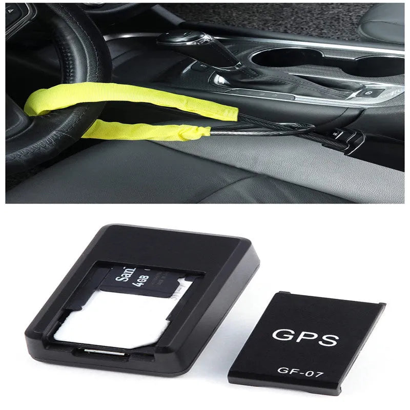 Small black magnetic GPS car tracker with USB charging cable on a metal surface.