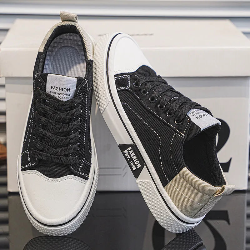 Men's blue low-top canvas skateboard shoes with round toe and white lace-up front.