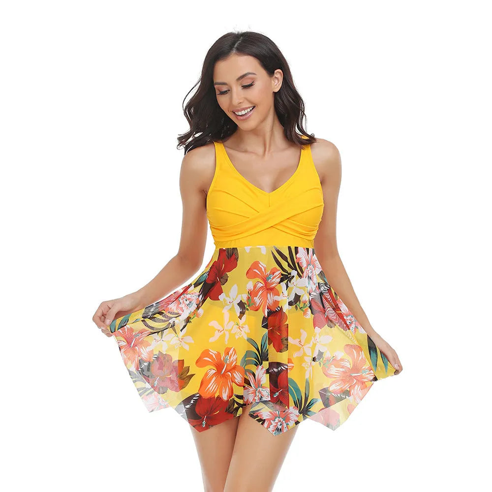 Women's one-piece swimsuit with a black tulle skirt and split-leg design on a mannequin.