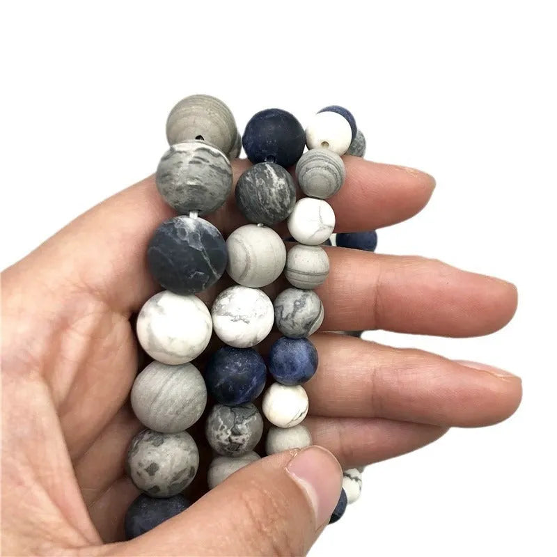 Handmade planet stone men's bracelet in U-shape, S228 Universe Wind design on wrist.