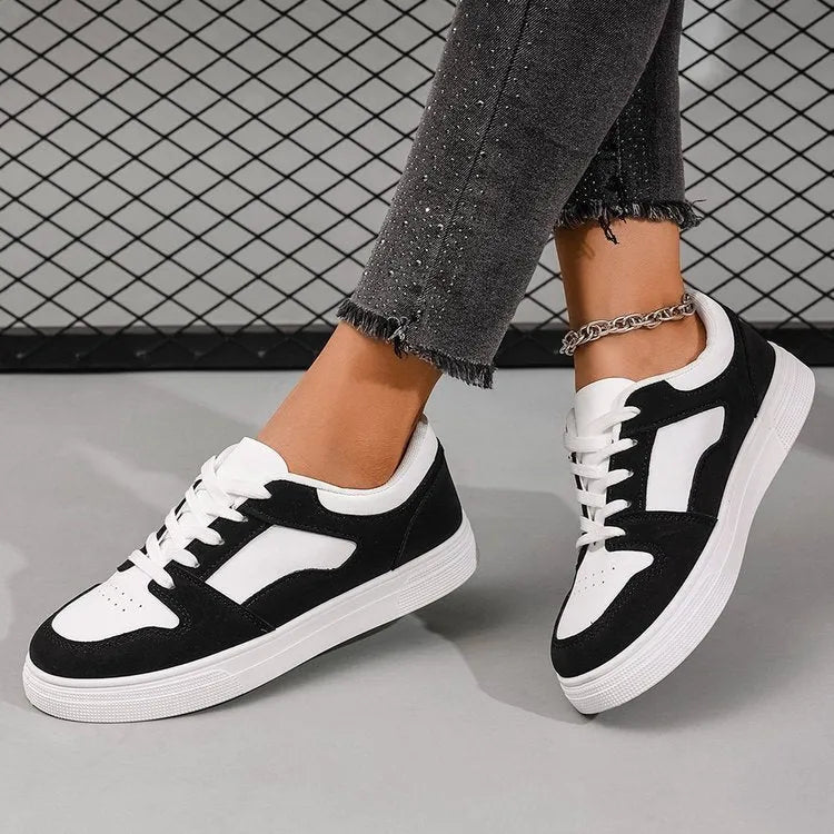 Black women's casual sports shoes with flat rubber sole and lace-up front