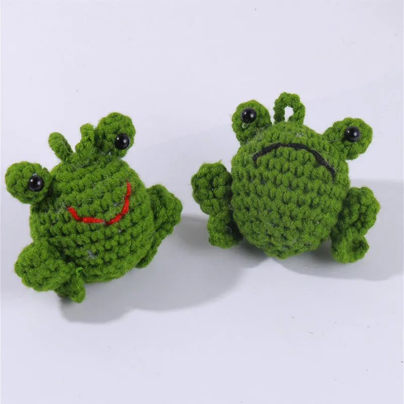 Handmade green plush frog car pendant hanging, showing woven cord and cartoon style.