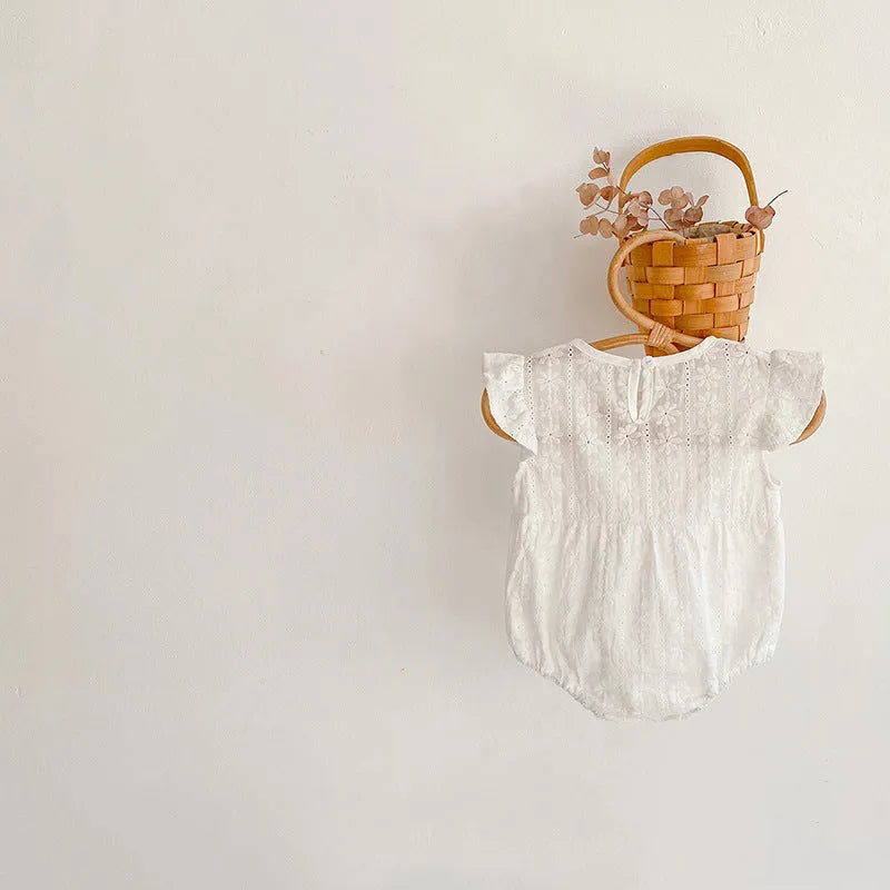 Creamy white cotton lace triangle jumpsuit for baby girl with short sleeves and button closure