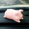A hard resin cartoon pig car dashboard ornament in one of eight available decorative styles.
