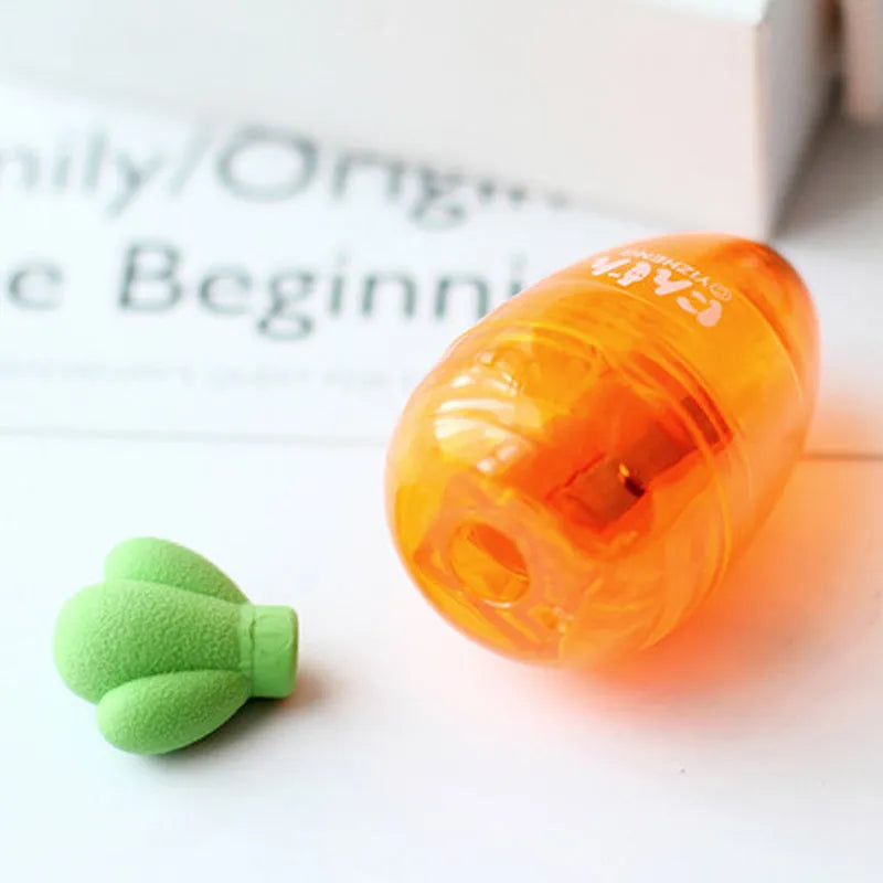 Orange carrot-shaped plastic pencil sharpener on a white background.