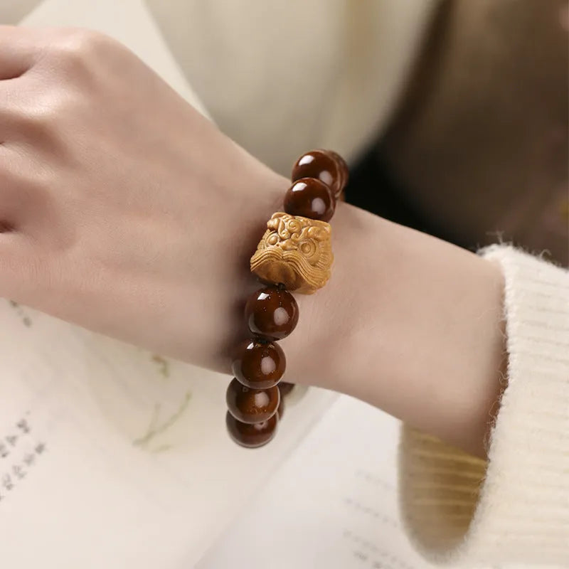 Hand-woven 13mm round bead bracelet with artistic lion designs in ivory nut, sandalwood or yellow gradient bodhi colours