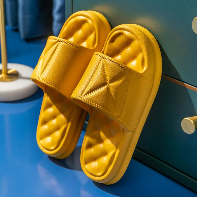 A pair of soft EVA bathroom slippers with a thick sole, shown in a choice of colours including black, caramel, green, pink, and yellow.